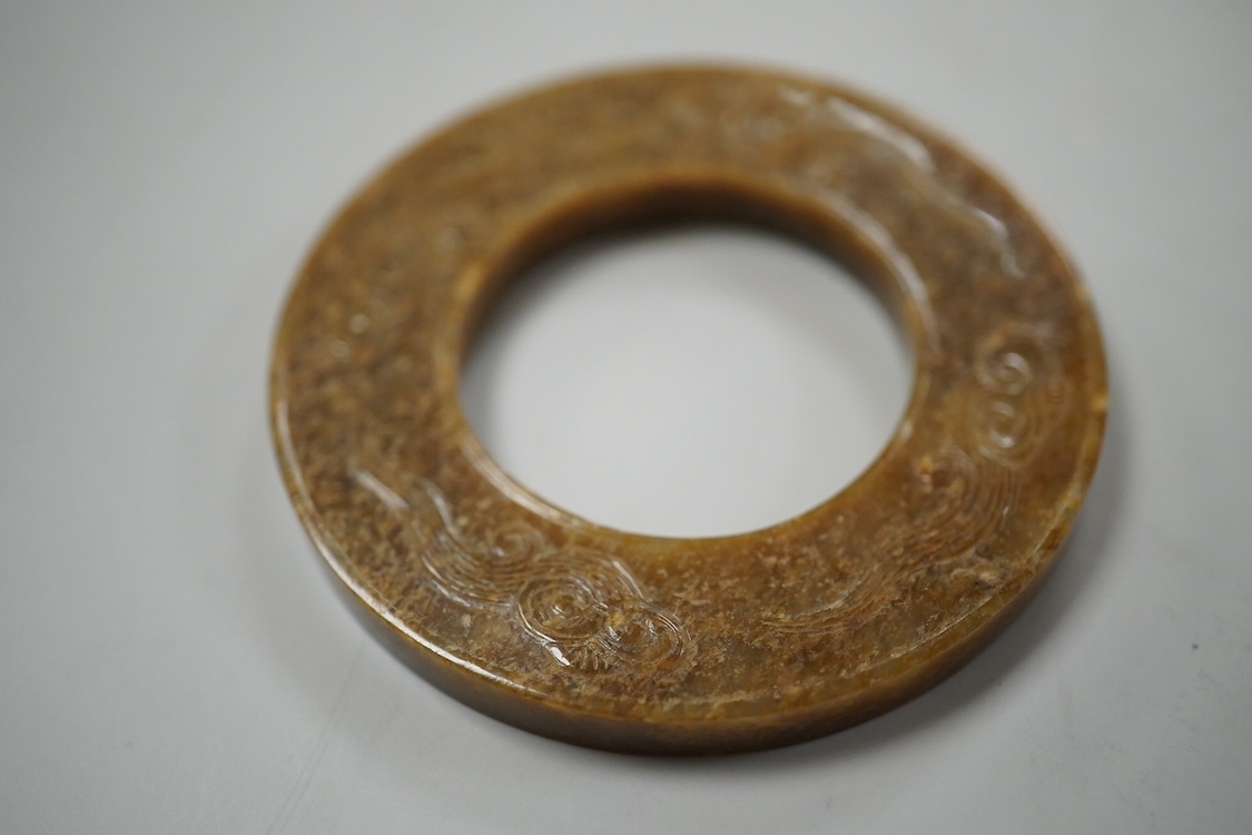 A Chinese russet jade dragon disc, 5.5cm diameter